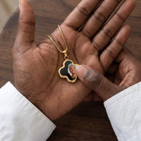 Thumbnail for Thumb warming the gold clover pendant: the hidden photo appears under the thumb while the rest stays black | SKU: TPH-CLVN-GOLD