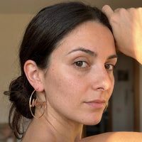 Thumbnail for Custom Name Hoop Earrings in Rose Gold worn on the ear, close-up on a model | SKU: name-hoop-rose-gold-30-mm