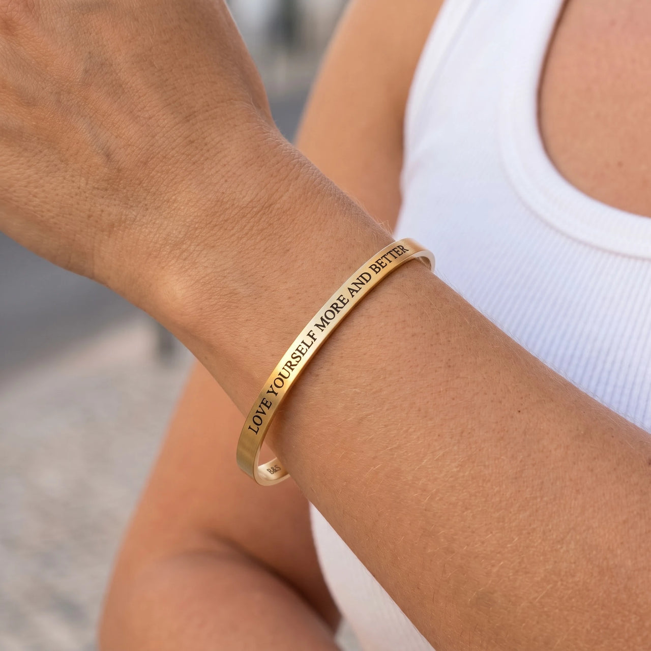 Close-up of the Love Yourself More And Better bracelet in gold worn | SKU: lymab-g