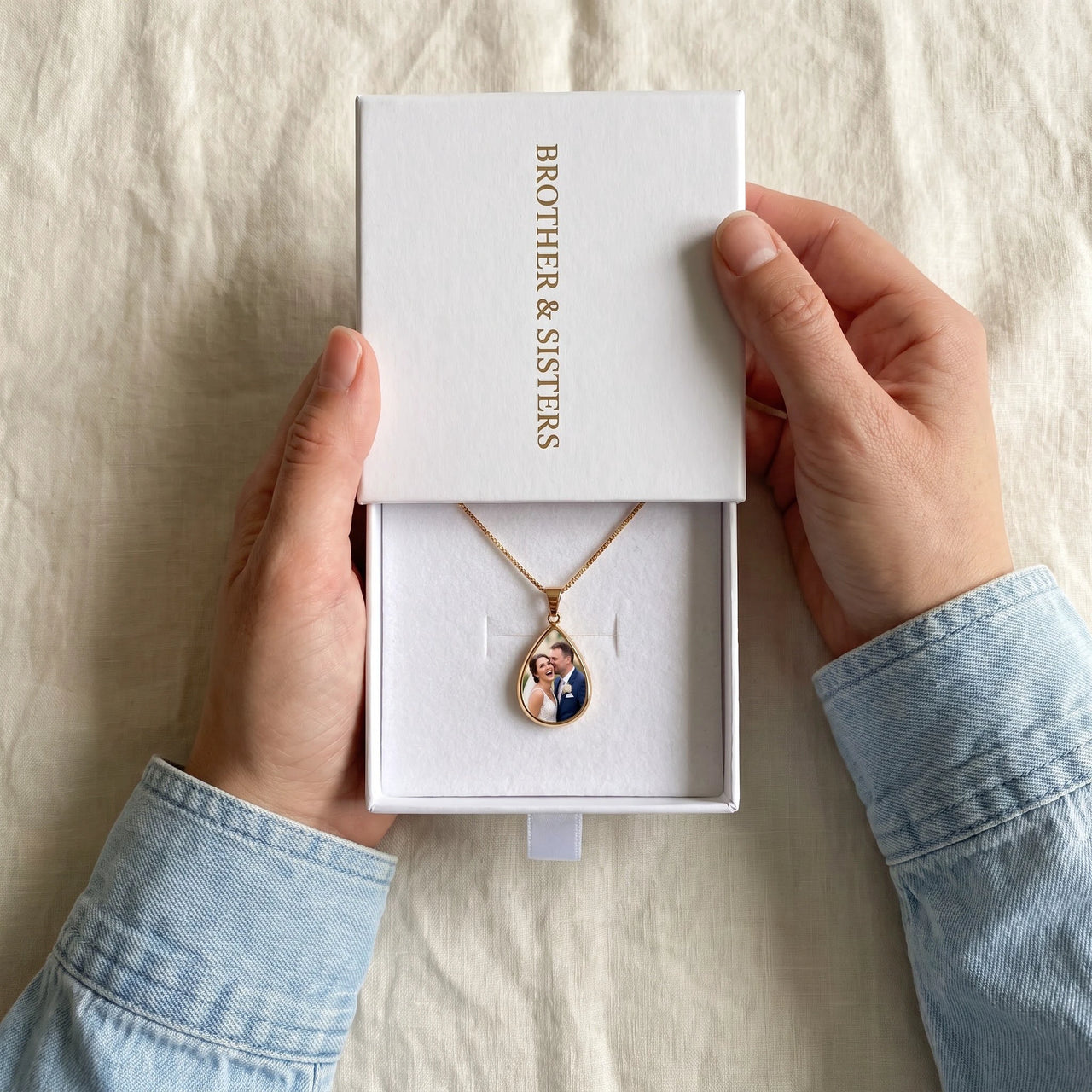The gold drop photo necklace with a wedding photo in the Brother & Sisters gift box | SKU: TPH-DRPN-GOLD