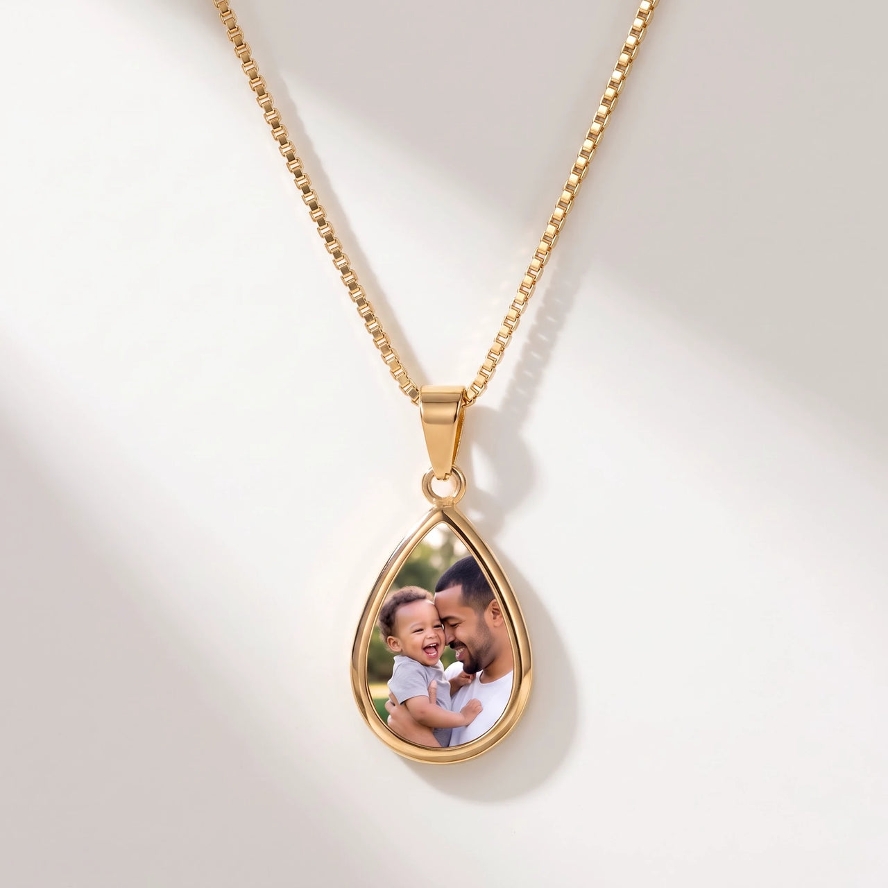 Secret Drop Photo Necklace in gold, teardrop pendant on a box chain showing the hidden photo | SKU: TPH-DRPN-GOLD