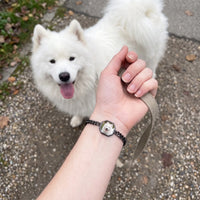 Thumbnail for Customer photo: the black octagon bracelet with her samoyed's photo, her dog in the background | SKU: TPH-OCTB-BLACK-18